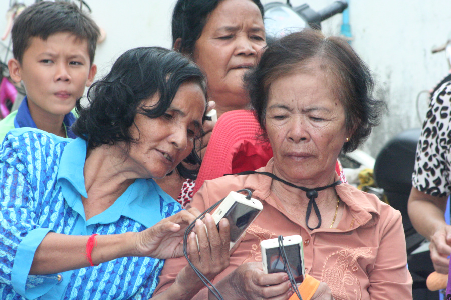 women observing the radio set